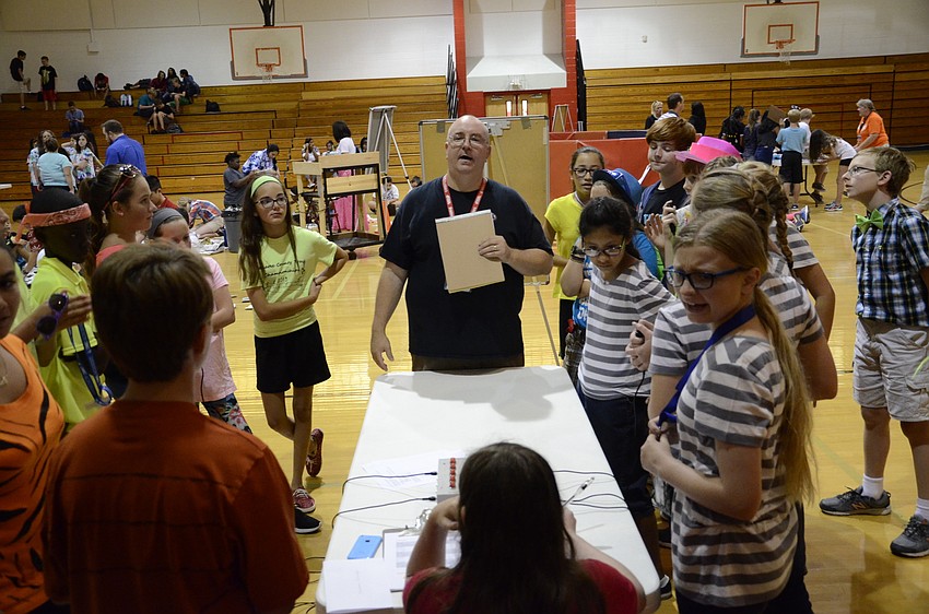 Civics teacher Chris Brown quizzes teams on trivia.