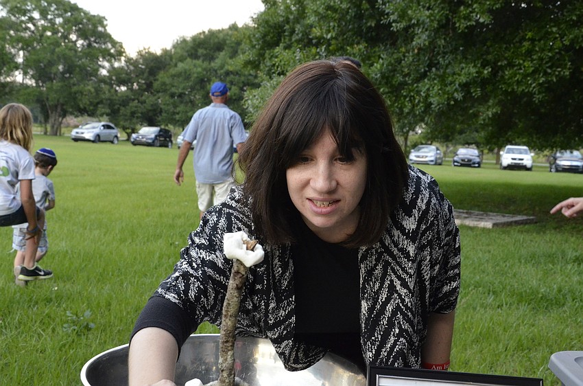 Chanie Bukiet hands out marshmallows for the fire.