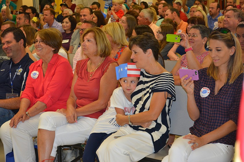Cheryl Buchler hugs her daughter, Gene Witt first-grader Emma Buchler after she spoke in front of the crowd at Witt's Memorial Day Weekend Celebration.