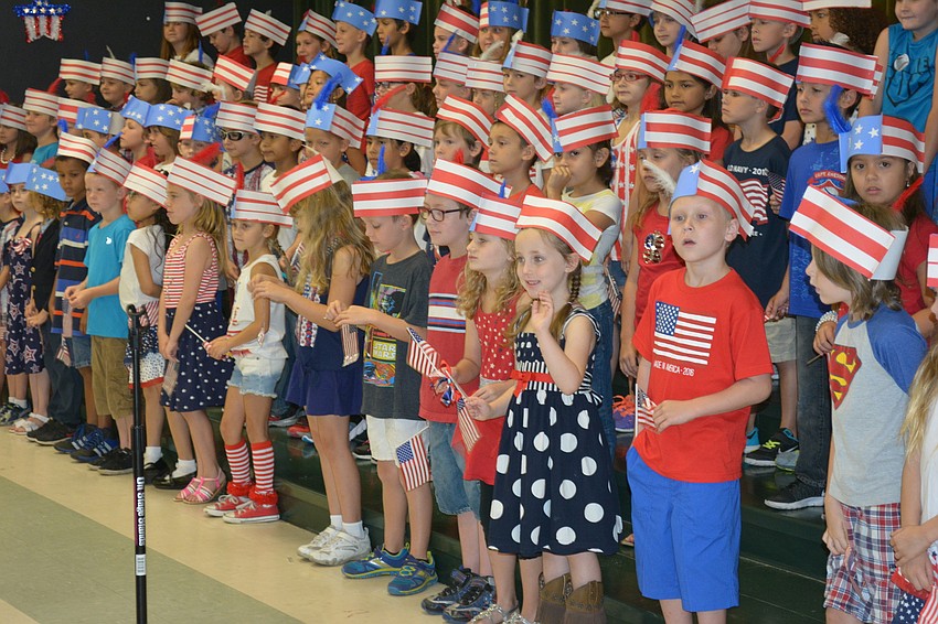 Lillianne Dickerman spots her family in the crowd and gives a wave.