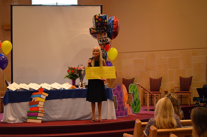 The Gan Director Laura Freedman presents a check for $184.34 to be donated to the American Cancer Society.