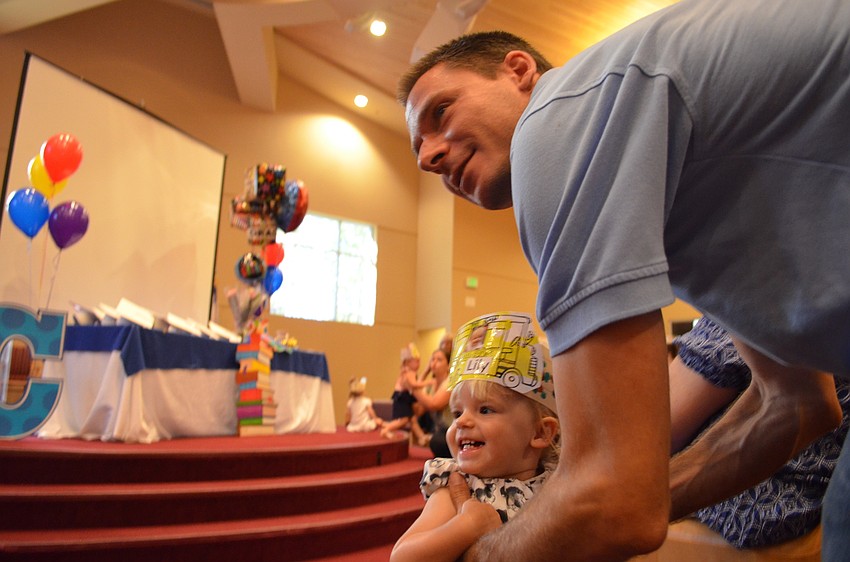 Lily runs to her father Daniel Brock.
