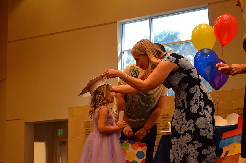 Sloan Rosenberg receives her cap and diploma.