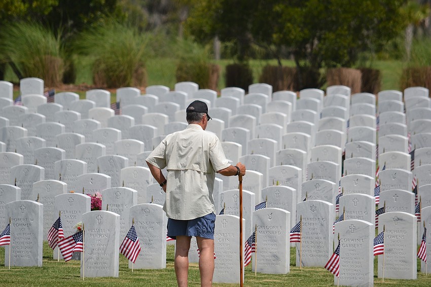 Vietnam veteran George Laessig pays his respects to the men and women buried at Sarasota National Cemetery.