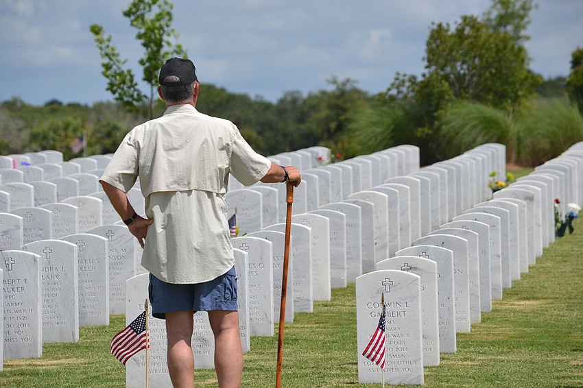 Vietnam veteran George Laessig pays his respects to the men and women buried at Sarasota National Cemetery.