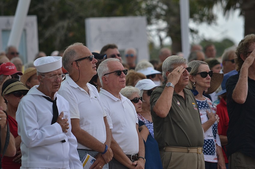 Audience members stand for the 