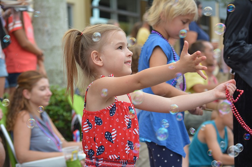 Lakewood Ranch's Lexi Sapanero, 4, had a wonderful time catching beads and bubbles.