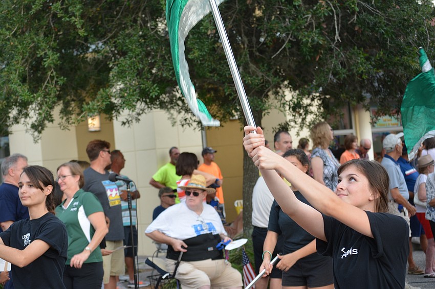 Aliyah Hurt of Lakewood Ranch High School's marching band twirls her flag.