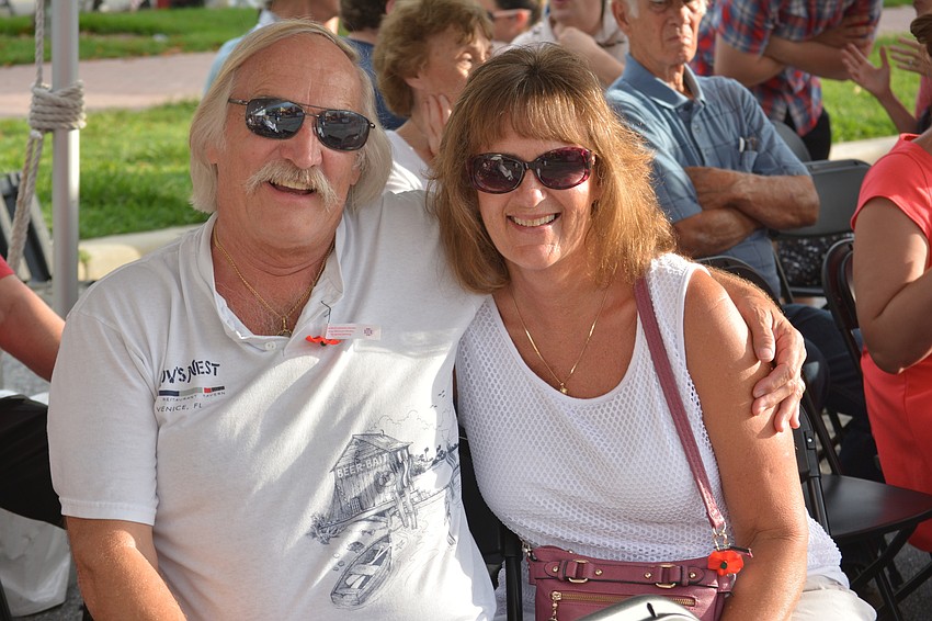 Sarasota's Frank Decker, a retired Army corporal, enjoys the parade from the VIP section with his wife, Pam.