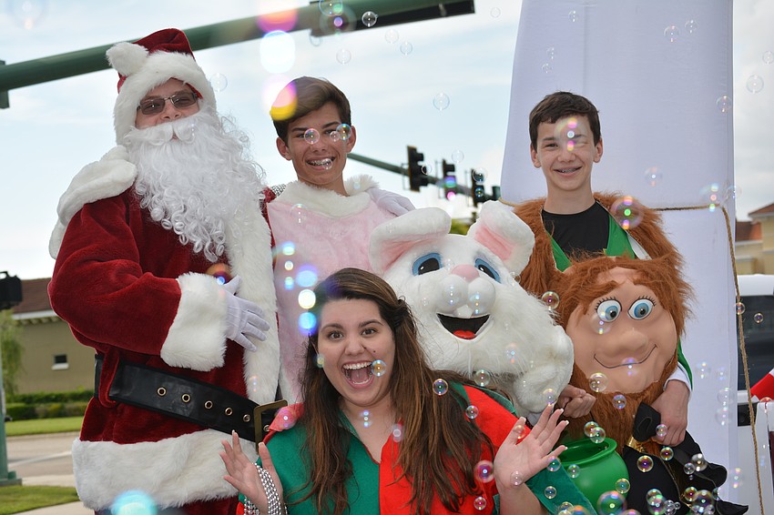 Santa, played by Leeson Foullon, the bunny, played by Daniel Wilkinson, the leprechaun, played by Jack Wilkinson, and an elf, played by Helena Beltrao, all rode the Lakewood Ranch Community Activities float.