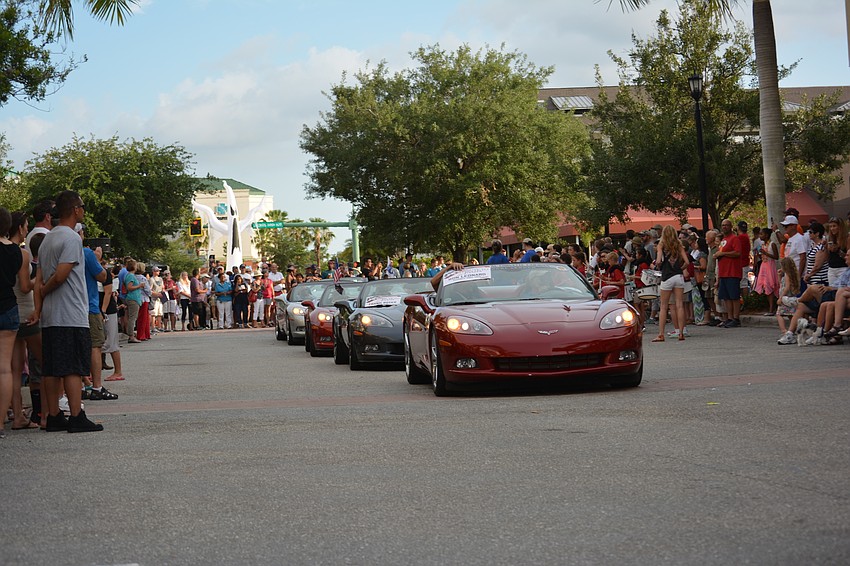 A string of Corvettes make their way down Lakewood Main Street.