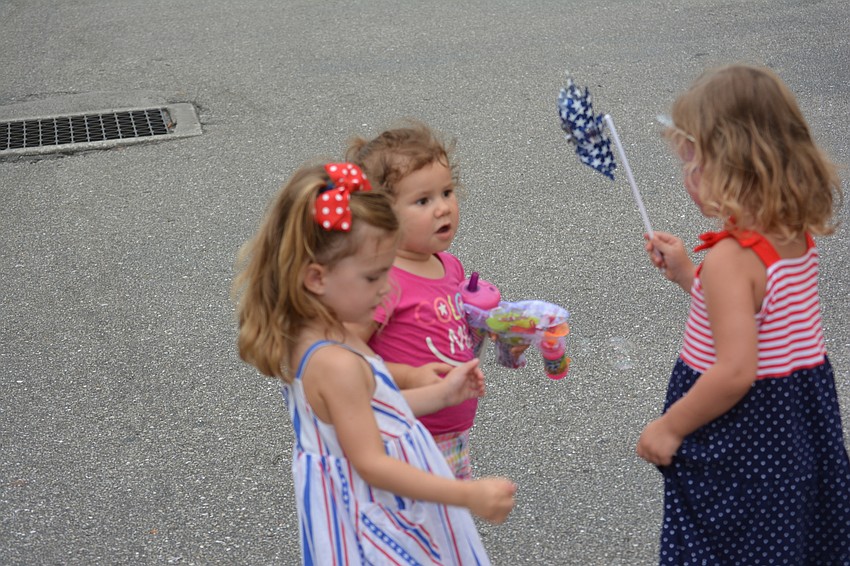 Katelyn McIntyre, 3, Emma Morales, 2 and Brielle Hodges, 4, enjoy a pinwheel.