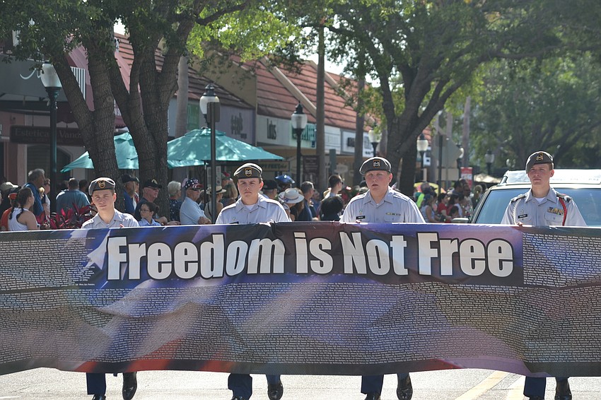 Sarasota Military Academy cadets hold the banner with names of members of the military who have died while serving.
