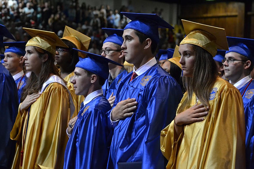 Students stand for the singing of the national anthem.