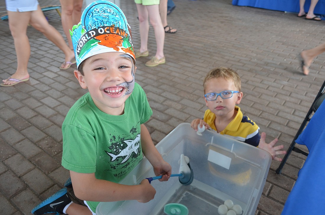 File photo. Meelan Gonzalez, 5, and Connor Treffert, 5 play a game at the 2015 Mote World's Ocean Day.