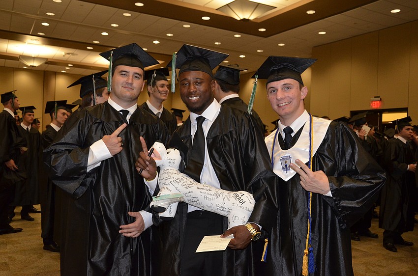 Scott Sams, Tyree Rome and Bradley Roeder. Rome had all his friends sign Chester the dog to remember his success. 