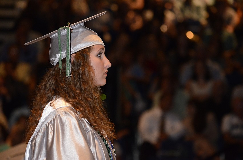 Chloe Gingerich stands in recognition of receiving the Lakewood Legends award. Faculty voted on three seniors who exemplify excellence in academics, leadership, citizenship and community service. Carly Patterson and Kailyn Scully also received the award.