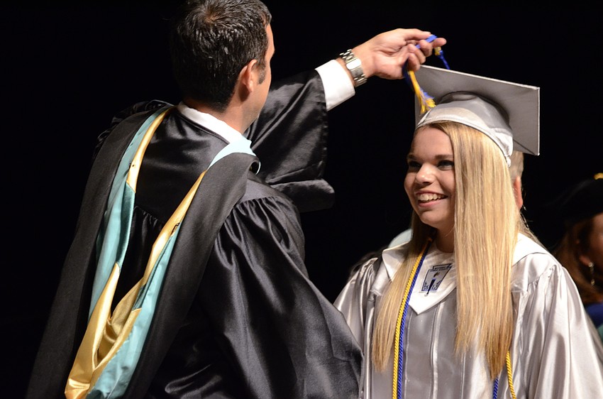 Principal Craig Little flips the tassel of Anna Kwiatkowski.