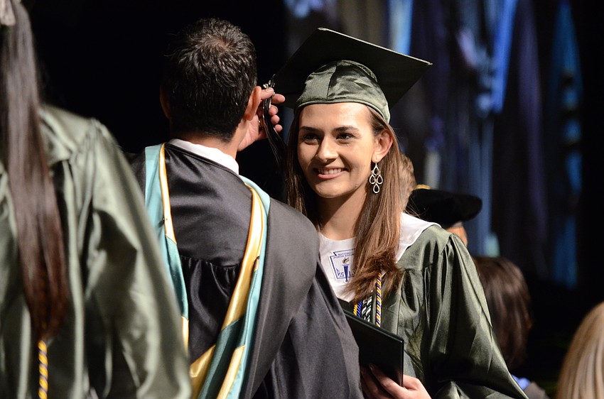 Elizabeth Ciemniecki shakes Principal Craig Little's hand.