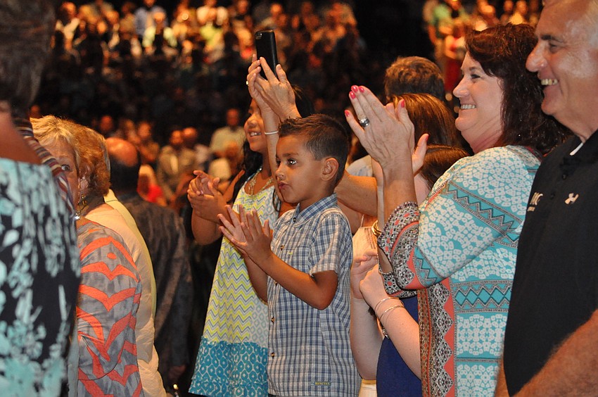 Nathan Grim and Linda Balavage clap as Grim's brother, Hayden, walks in.