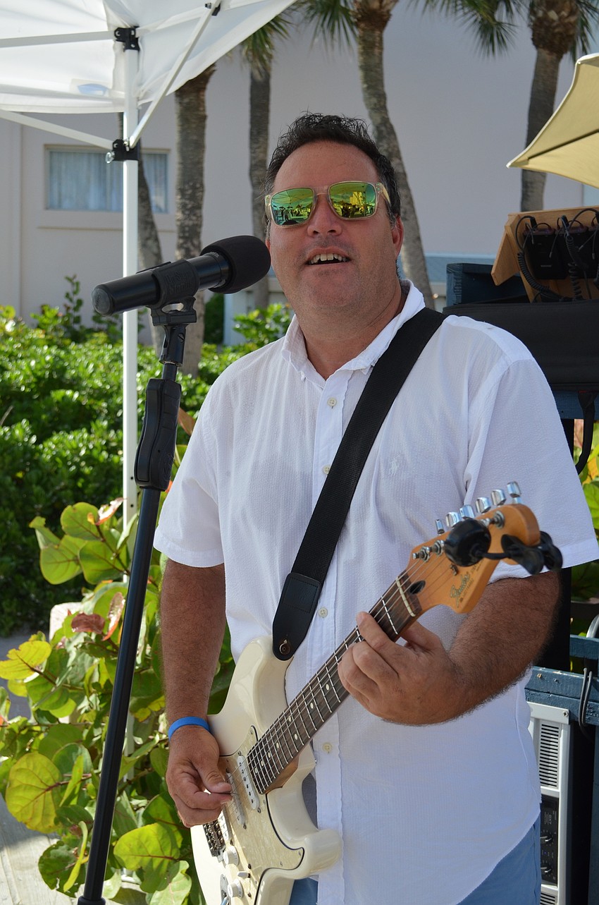 Performer Mike Sales played guitar and sang for guests.