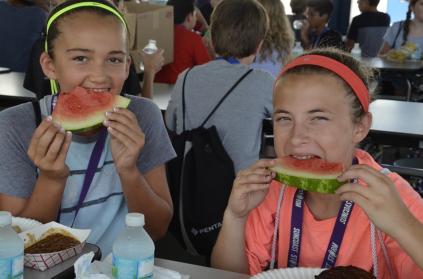 Riley O'Neill and Dani Taraska chow down on watermelon.
