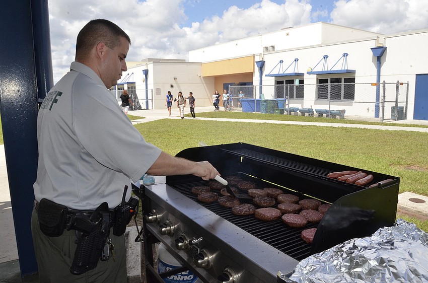 John Proll, Manatee County Sheriff's Office school resource officer, cooks lunch for the sixth-graders.