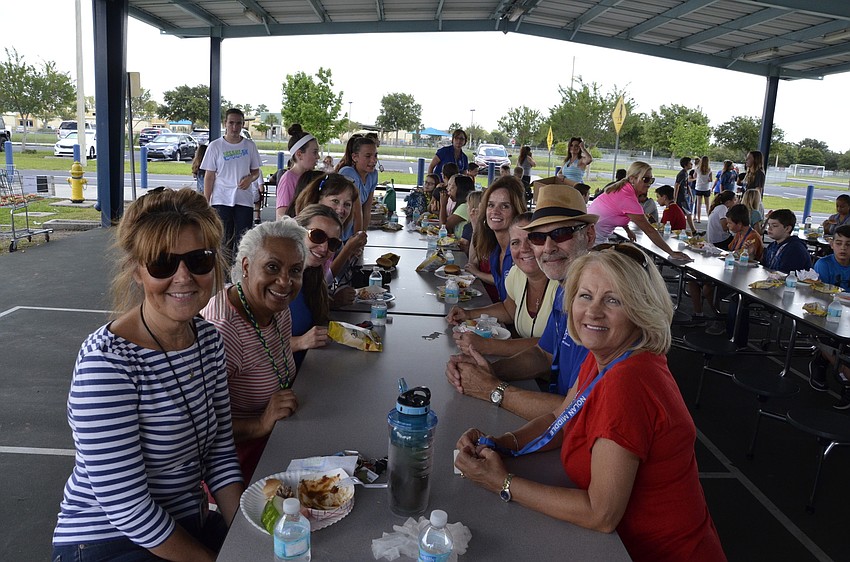 Teachers and event organizers take a minute to grab a bite and chat during lunch.