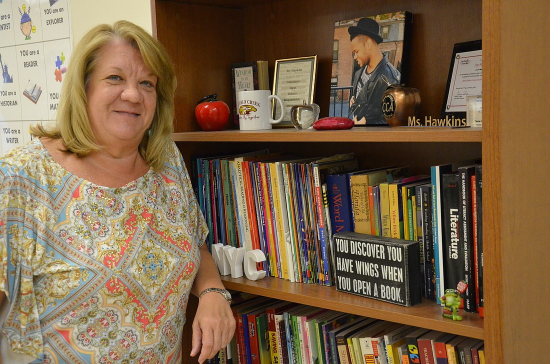 Joy Hawkins keeps a bookcase of her favorites in her classroom at Buffalo Creek Middle School.