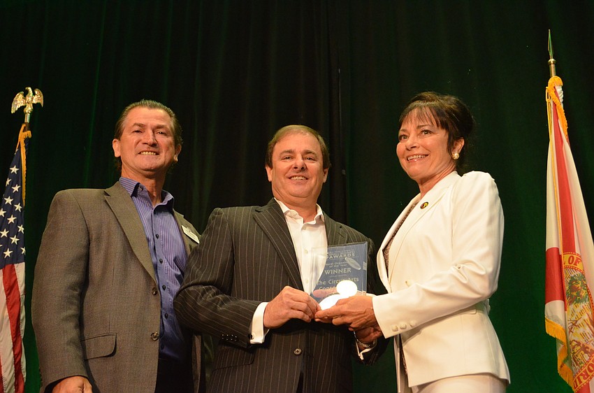 Pedro Reis and Dolly Jacobs receive the award for Cultural Organization of the Year from Bryan McDonald.