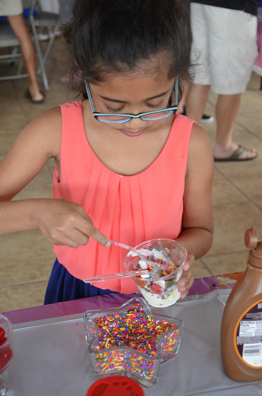 Namita Kondabala gets a spoonful of sprinkles for her ice cream.