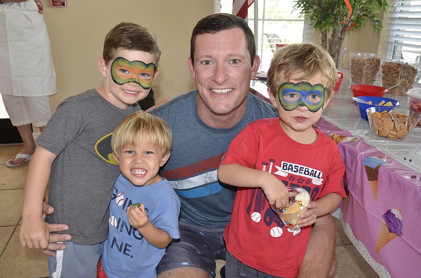 Ben Kloss jumps in with his neighbor, Justin Reynolds and his sons, Chase and Riley.