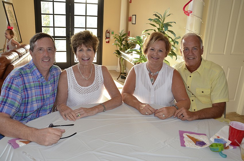 John and Connie Rhodes sit with future neighbors Renee and Dave Hollett. The Rhodes are waiting for their home to be finished before they move into the neighborhood.