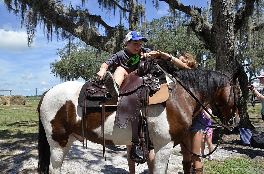 Logan Lawhorn of Port Charlotte gets a ride on Jasper.