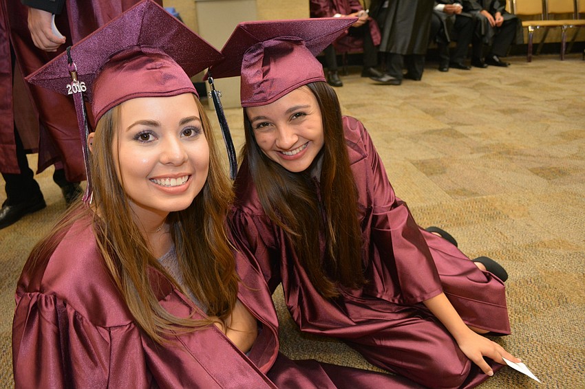 Gabriela Libreros and Ana Maria Linares Corrales sit and relax before commencement begins.