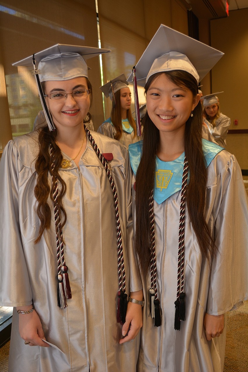 Hannah Figueras joins friend and valedictorian Molly Sun for a photo.