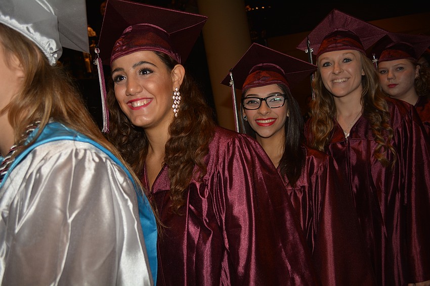Wafa Munshav, front, smiles as she enters the auditorium.