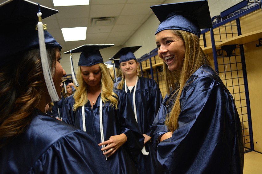 Jordan Bruder, right, laughs with friends before the ceremony begins.