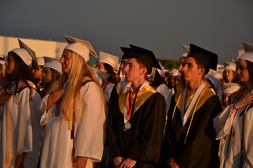 Students stand for the national anthem.