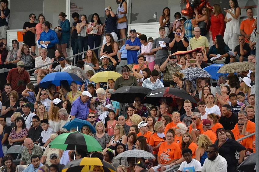 Some family members were willing to withstand the rain to watch their students graduate.