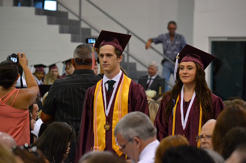Daniel Rees and Emily Poutney make their way toward the stage at Robarts Arena.