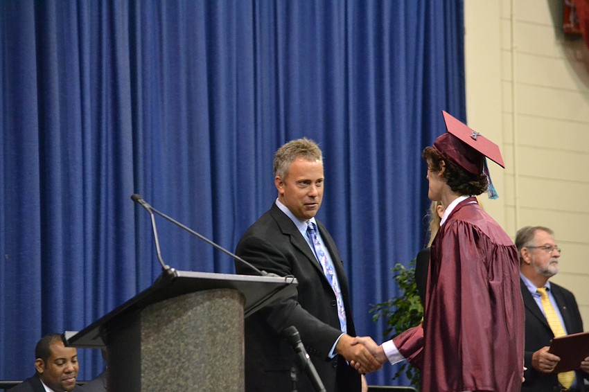 Riverview High School principal Eric Jackson congratulates Nicholas Sabattini.