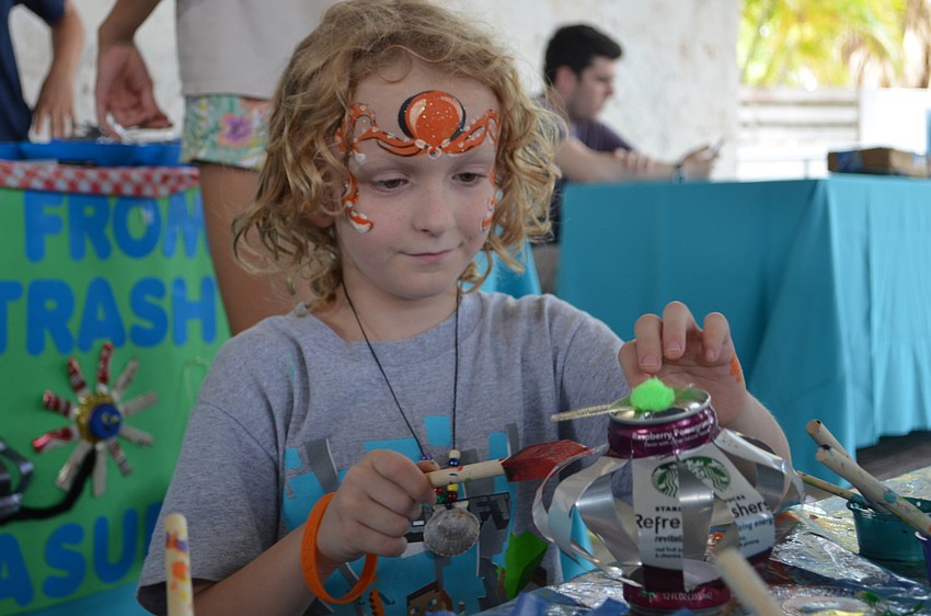 Cobyn Mannerud paints recycled materials.