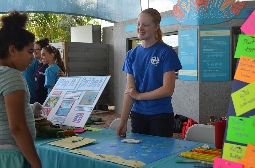 Mackenna Radunz explains her study project to pop balloons to prevent them from falling and polluting the ocean.