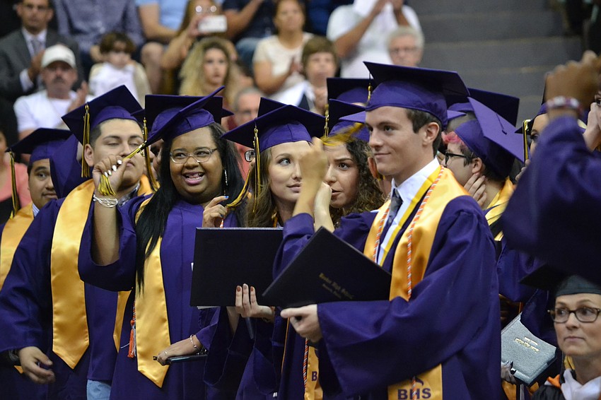 Students anxiously wait for the direction to turn their tassels.