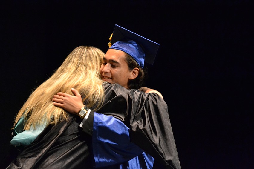 Pine View School senior class sponsor Robin Melton embraces Dino Bever.