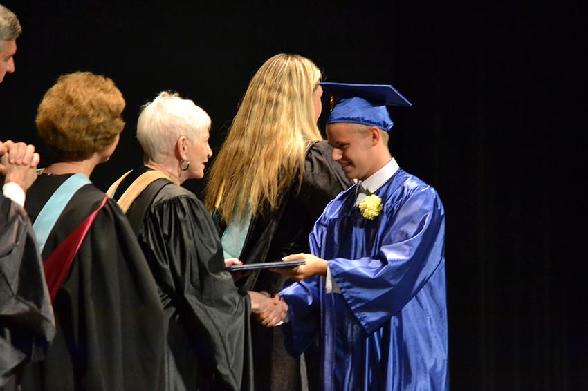 Michael Baiamonte receives his diploma from Sarasota County School Board member Caroline Zucker.