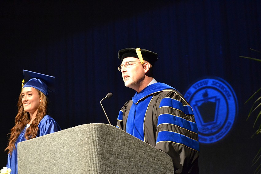 Pine View School Principal Stephen Covert presents graduate Olivia Augustine.