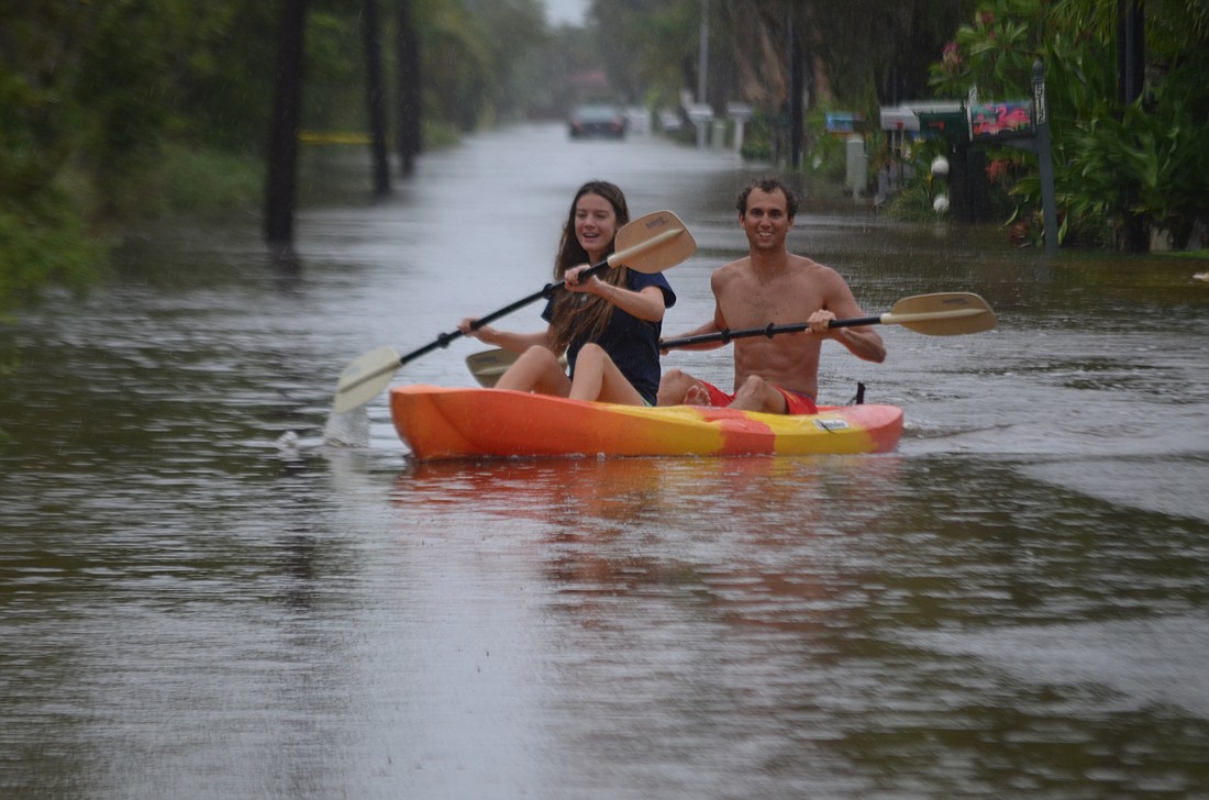 University of North Florida junior Max Moneuse, a Longboat Key native, and his girlfriend, UNF sophomore Tabitha Bingham, kayak down a flooded Lyons Lane on the north end of Longboat Key.