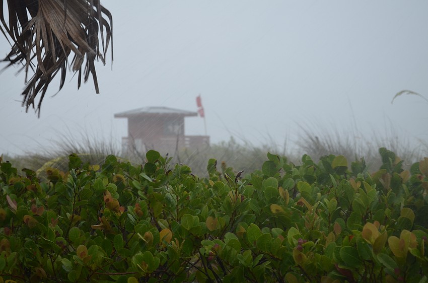 Wind whips a lifeguard stand at Lido Beach during Tropical Storm Colin.